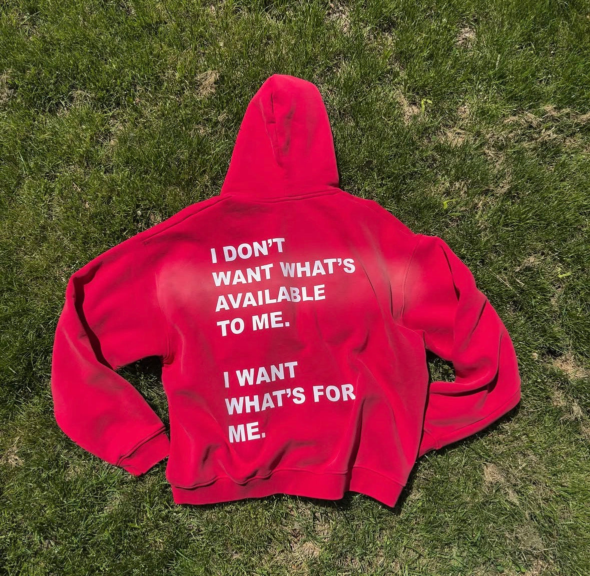 The Entry 004 hoodie in red, worn.